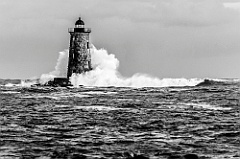 Giant Wave Surrounds Stone Lighthouse in Maine -BW